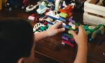 child playing with lego blocks